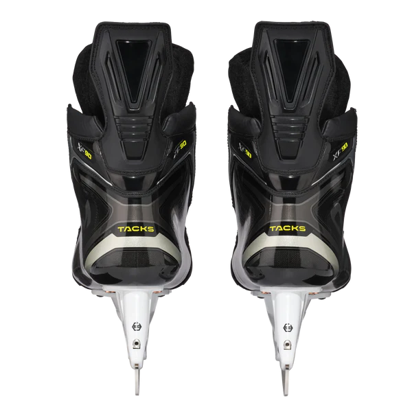 Pair of black hockey skates with white blades on a white background